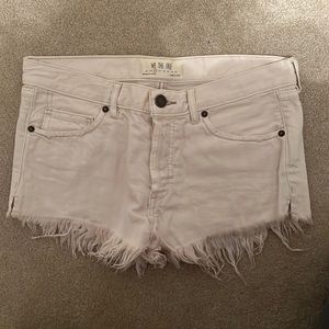 Free People distressed white jean shorts